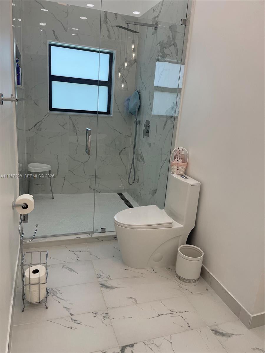 14200 Southwest 160th Court Miami, FL 33196 - Photo 19 of 36 a bathroom with a toilet and a shower