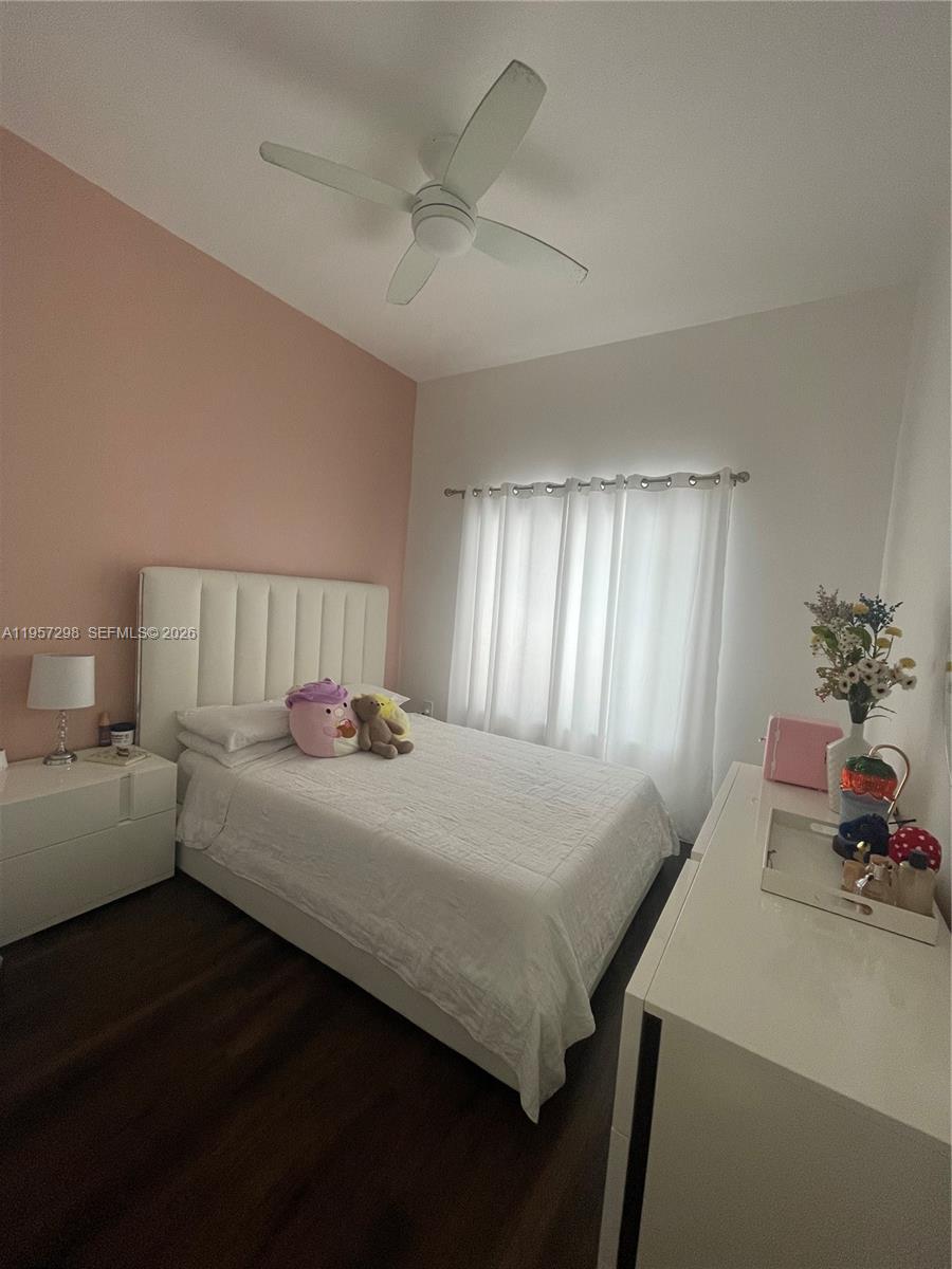 14200 Southwest 160th Court Miami, FL 33196 - Photo 21 of 36 a bedroom with a bed and a chandelier