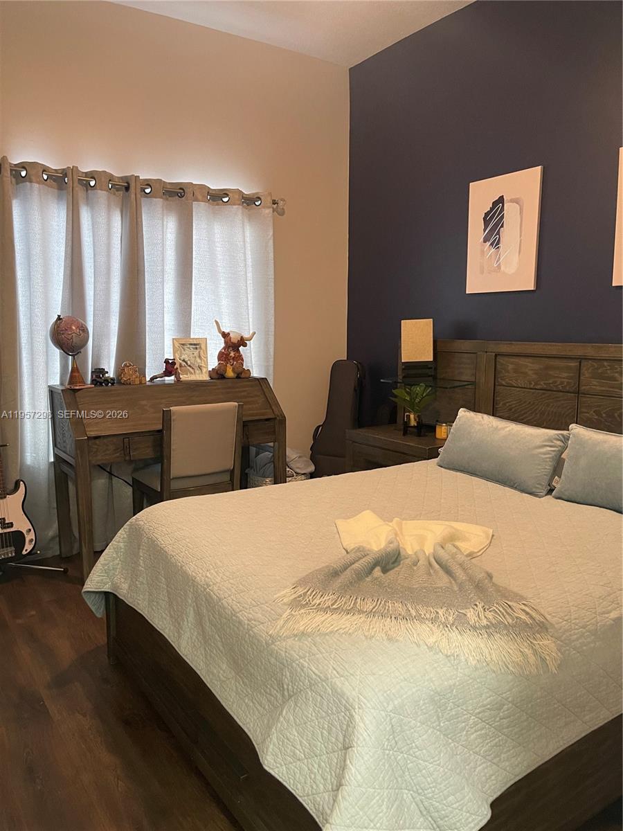 14200 Southwest 160th Court Miami, FL 33196 - Photo 22 of 36 a bedroom with a bed and a table