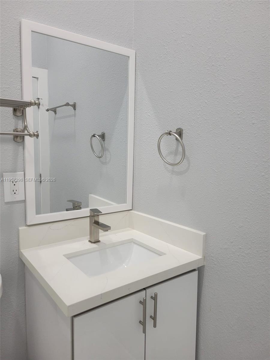 14200 Southwest 160th Court Miami, FL 33196 - Photo 29 of 36 a bathroom with a sink and a mirror