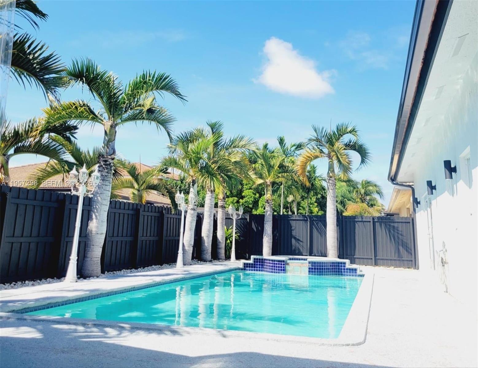 14200 Southwest 160th Court Miami, FL 33196 - Photo 30 of 36 a view of a house with a swimming pool