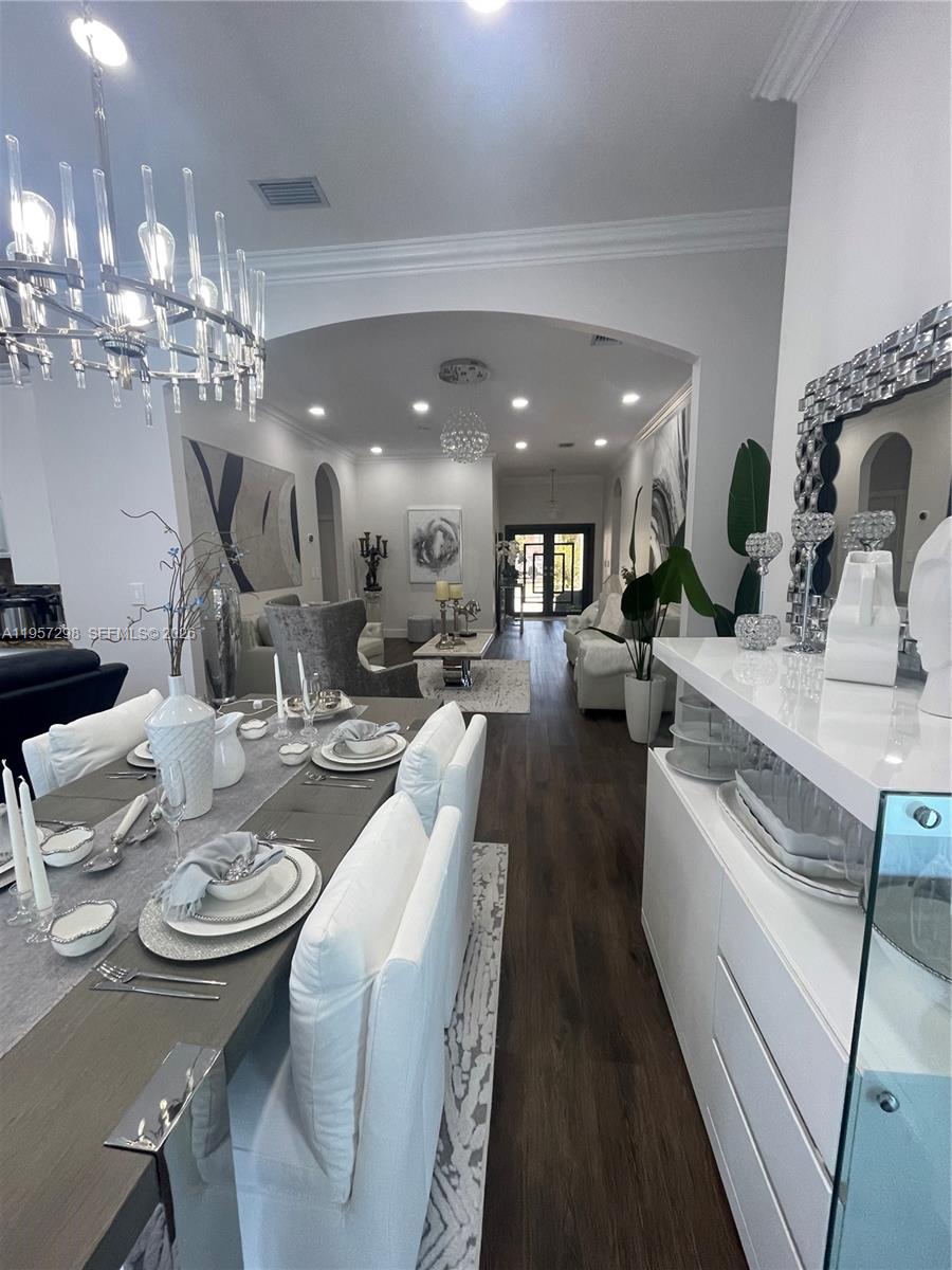 14200 Southwest 160th Court Miami, FL 33196 - Photo 6 of 36 a large kitchen with a table and chairs