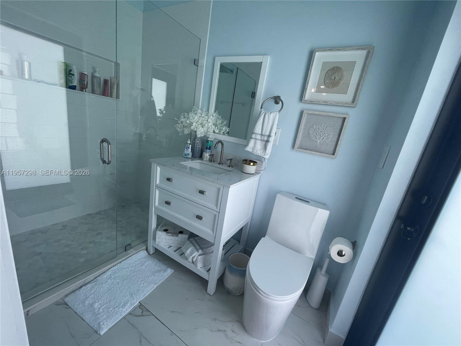 14200 Southwest 160th Court Miami, FL 33196 - Photo 10 of 36 a bathroom with a sink a toilet and shower