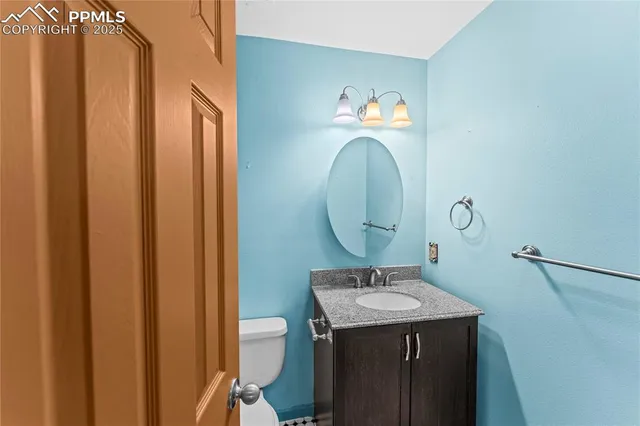 a bathroom with a sink mirror and vanity
