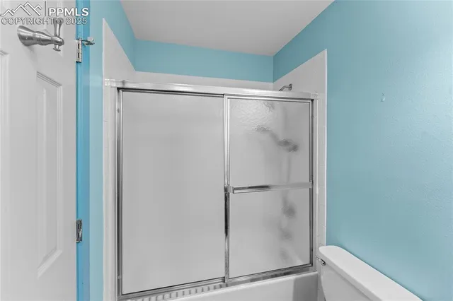 a bathroom with a glass shower door