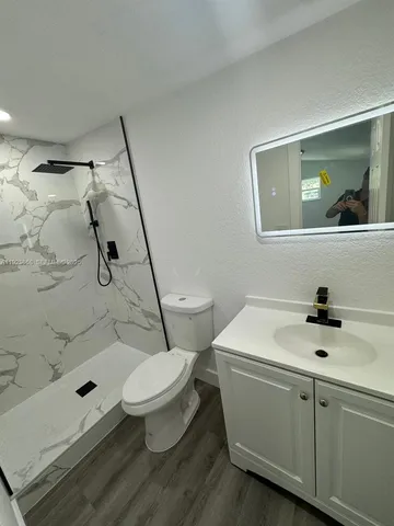 a bathroom with a toilet and shower