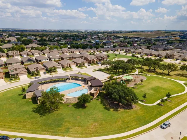 an aerial view of residential houses with outdoor space