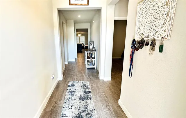 a kitchen with stainless steel appliances a sink a counter top space a large window and furniture