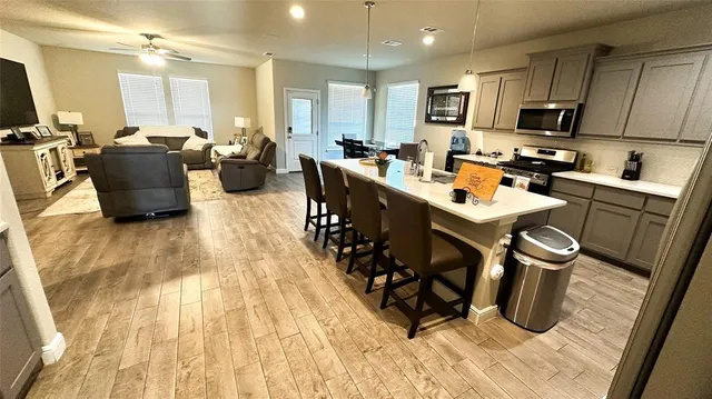 a kitchen with a sink stove and cabinets