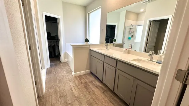 a bathroom with a bathtub a sink and a mirror