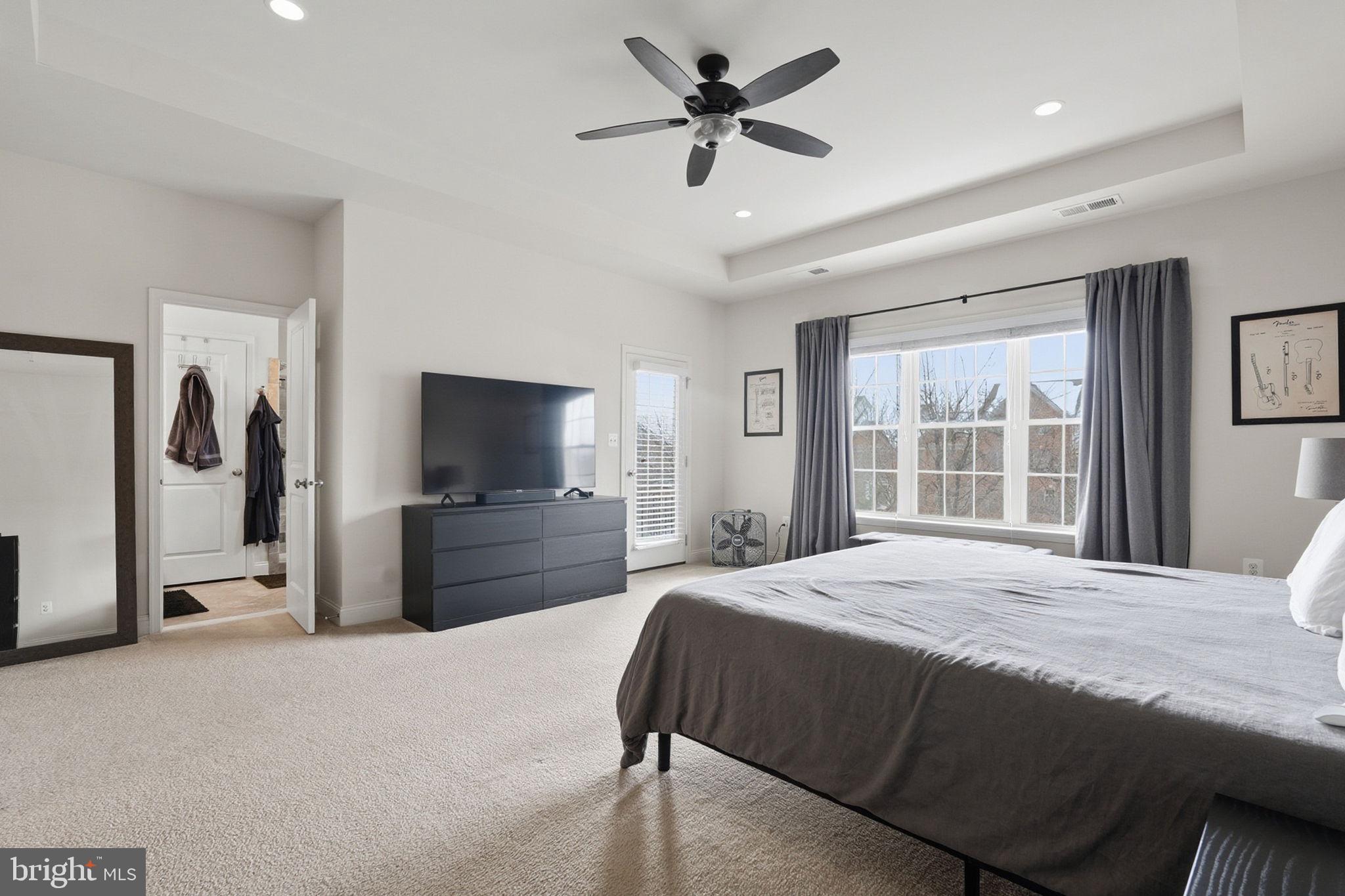 22597 Windsor Locks Square Ashburn, VA 20148 - Photo 22 of 44 a bedroom with a bed and a flat screen tv