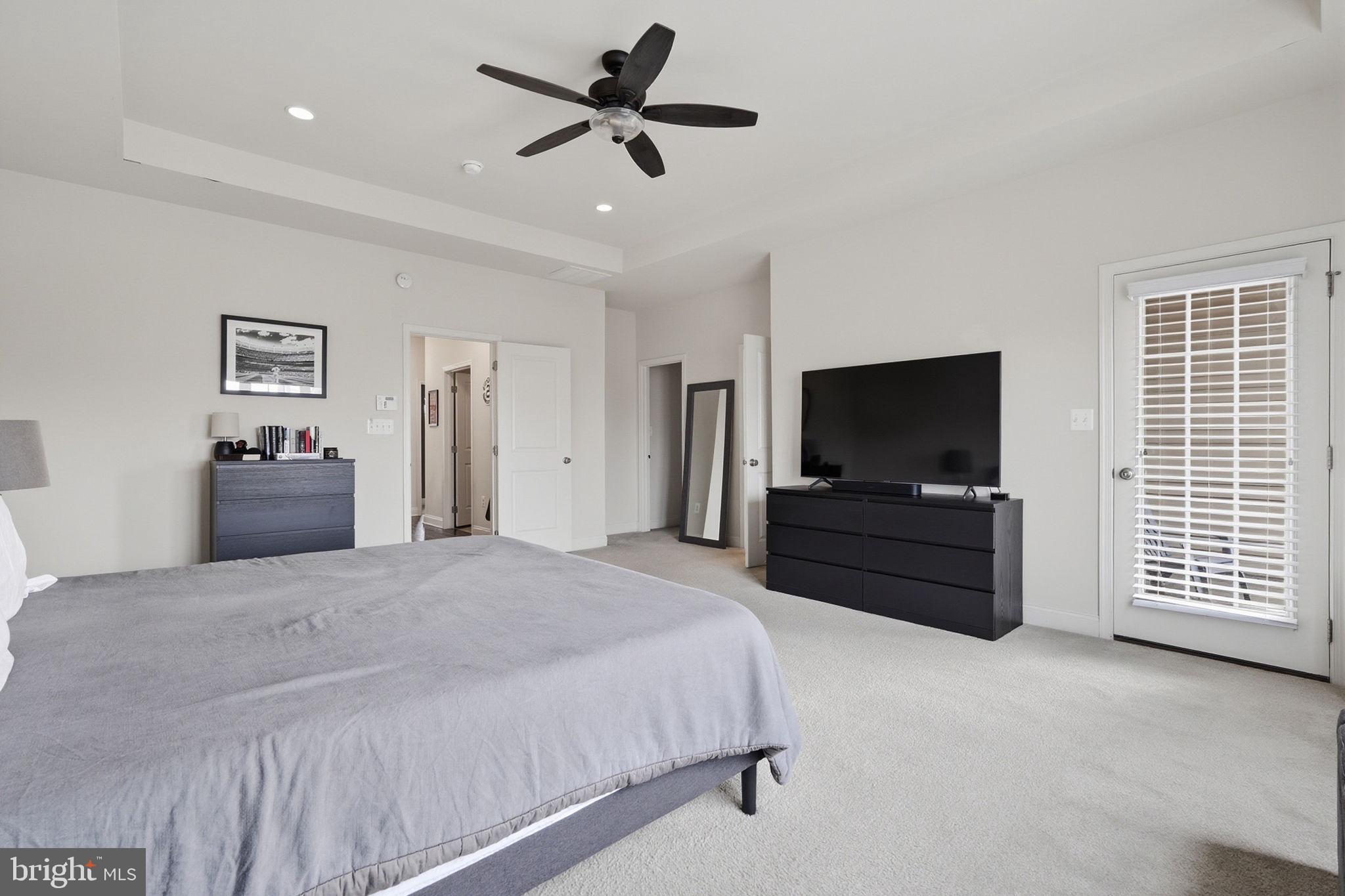 22597 Windsor Locks Square Ashburn, VA 20148 - Photo 23 of 44 a bedroom with a bed and a flat screen tv