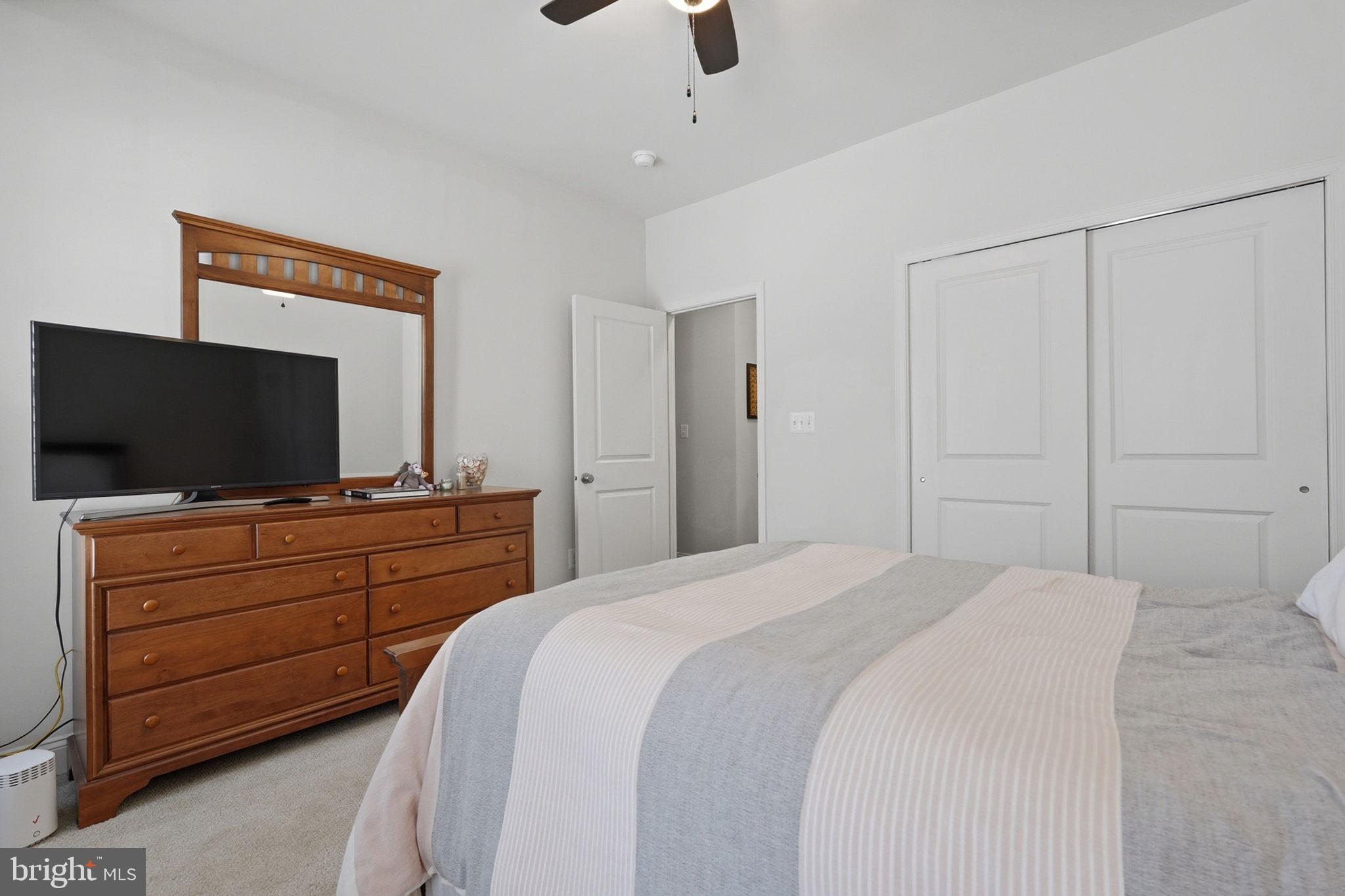 22597 Windsor Locks Square Ashburn, VA 20148 - Photo 27 of 44 a bedroom with a bed and a flat screen tv