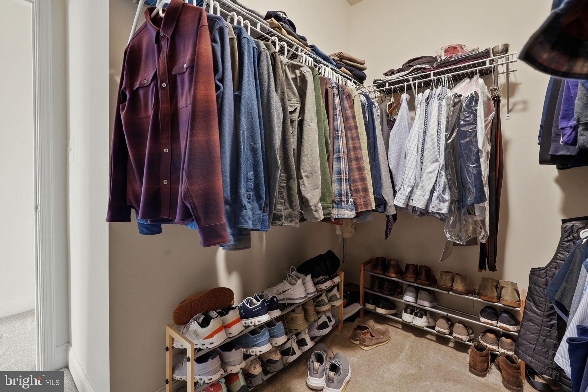 22597 Windsor Locks Square Ashburn, VA 20148 - Photo 28 of 44 a view of walk in closet with clothes and shoes