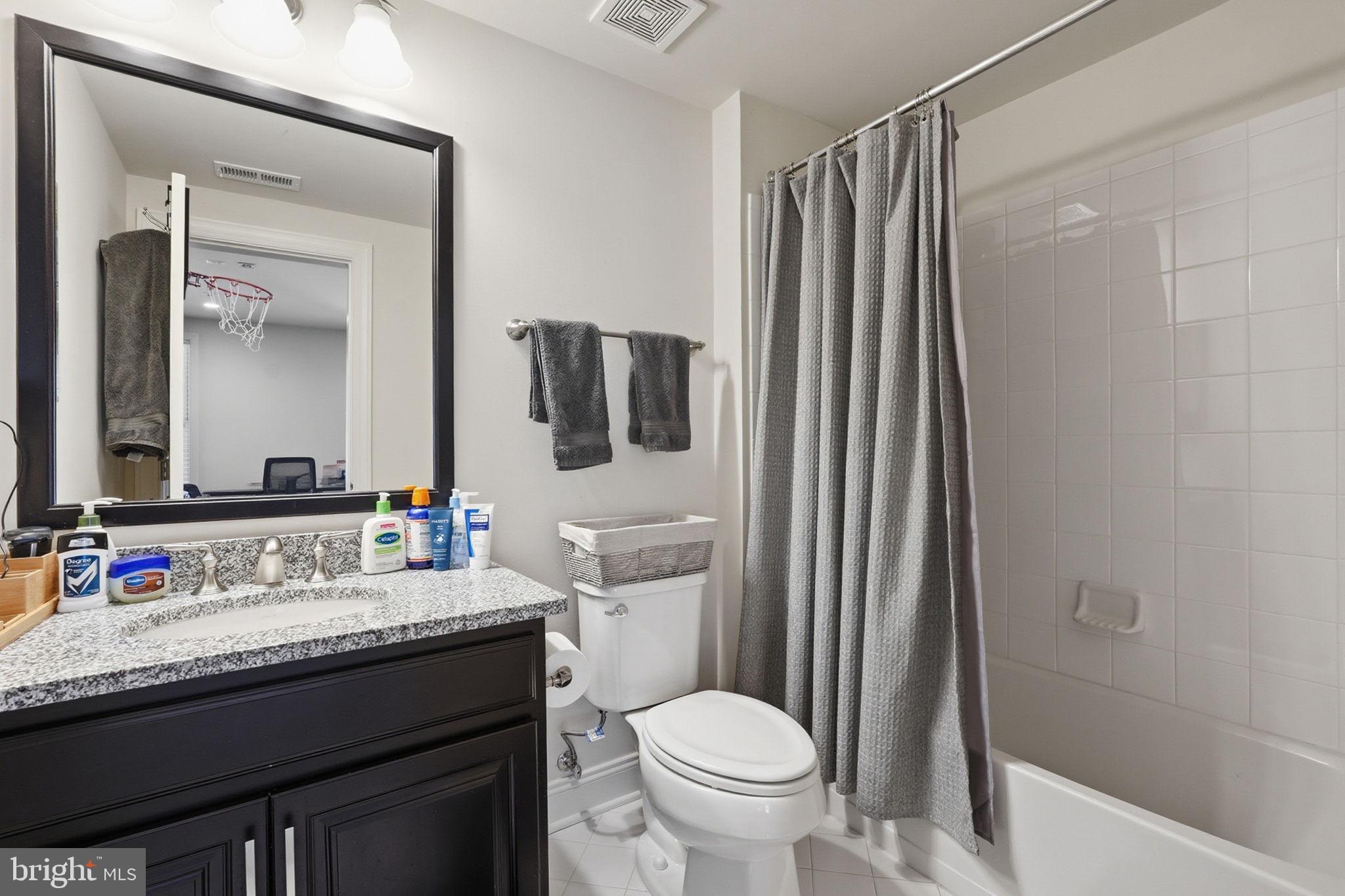 22597 Windsor Locks Square Ashburn, VA 20148 - Photo 29 of 44 a bathroom with a granite countertop sink toilet and shower