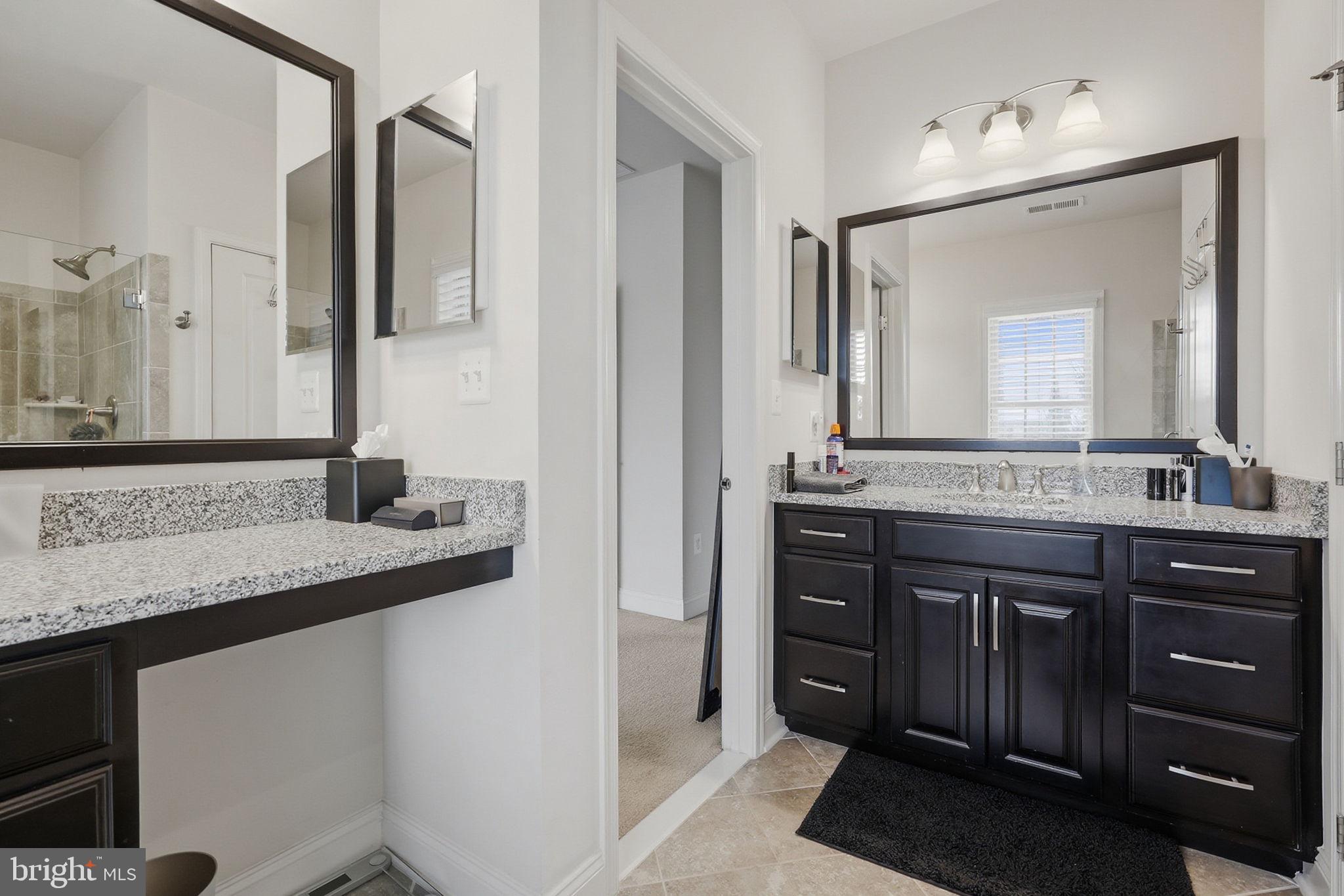 22597 Windsor Locks Square Ashburn, VA 20148 - Photo 31 of 44 a bathroom with a granite countertop sink and a mirror