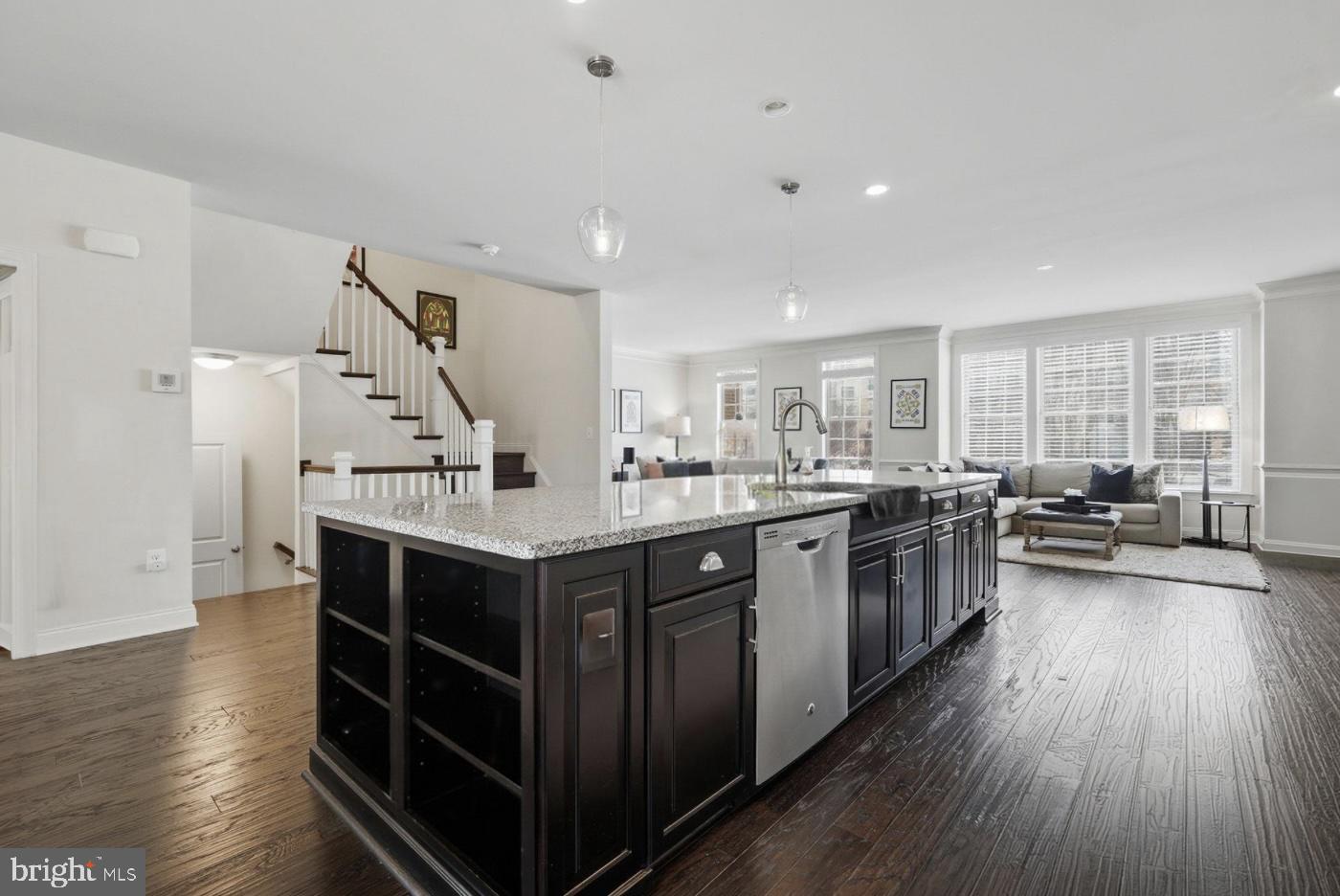 22597 Windsor Locks Square Ashburn, VA 20148 - Photo 4 of 44 a kitchen with stainless steel appliances granite countertop a lot of counter space and wooden floors