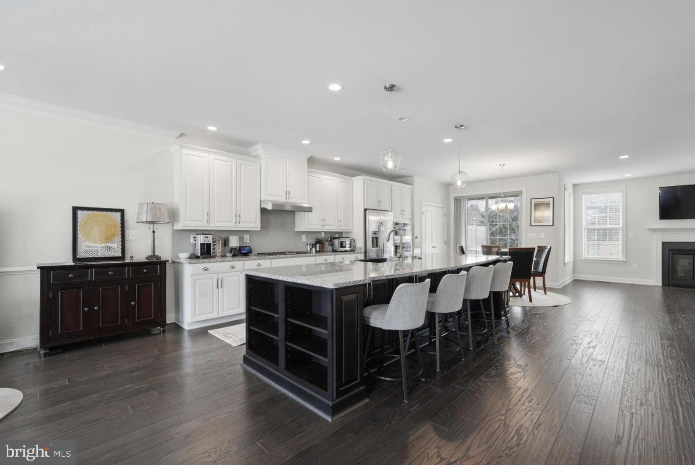 22597 Windsor Locks Square Ashburn, VA 20148 - Photo 5 of 44 a kitchen with a dining table chairs and wooden floor