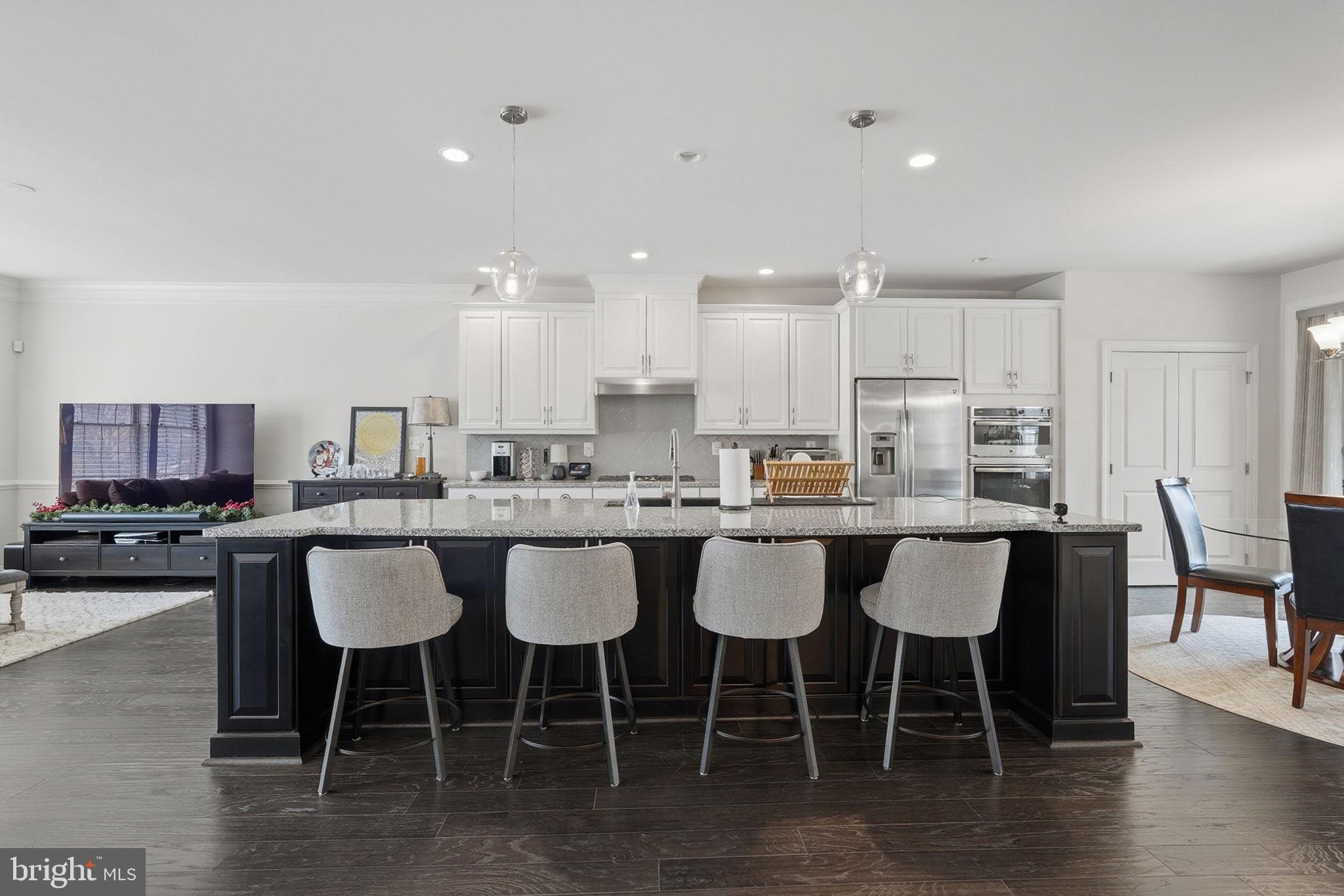 22597 Windsor Locks Square Ashburn, VA 20148 - Photo 8 of 44 a kitchen with a dining table chairs and view living room