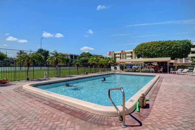a view of a swimming pool and lounge chairs