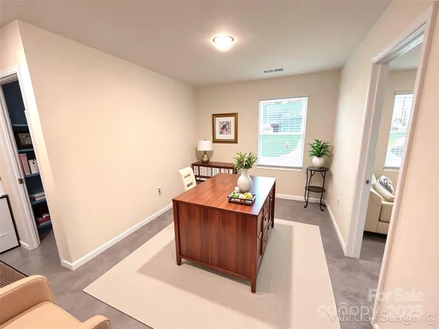 a view of a living room with furniture and a wooden floor