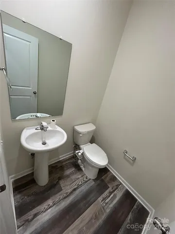 a bathroom with a sink toilet and a mirror