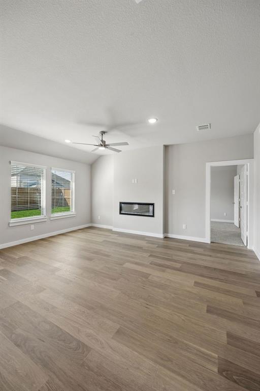 1424 Companero Street Haslet, TX 76052 - Photo 12 of 33 a view of an empty room with a window and wooden floor