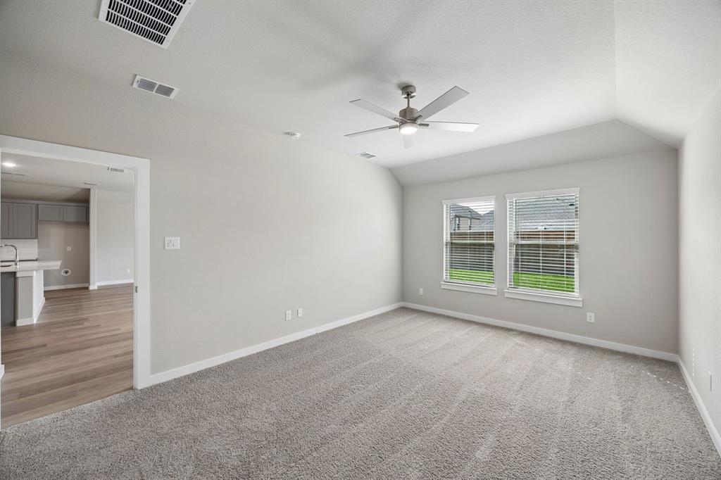 1424 Companero Street Haslet, TX 76052 - Photo 16 of 33 a view of empty room with wooden floor and fan