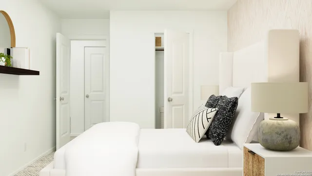 a bedroom with a bed and a mirror