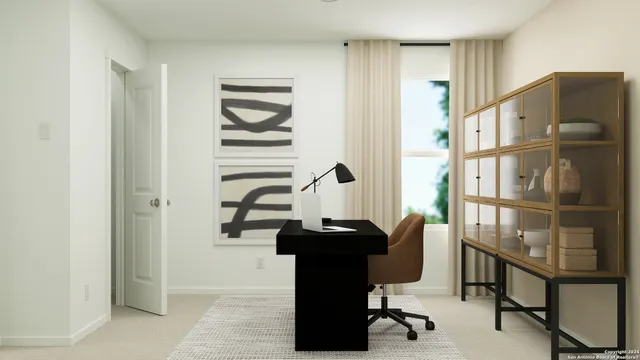 a view of a workspace with furniture and a window