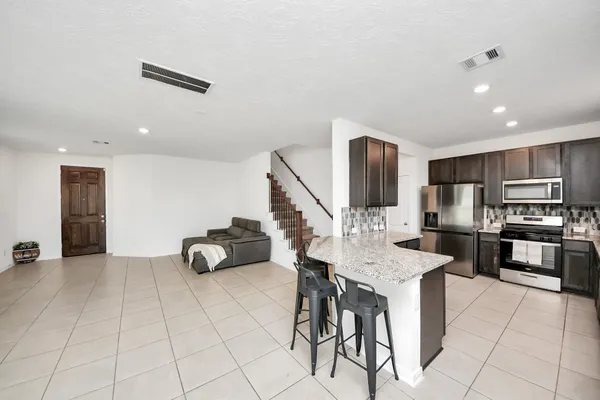 a large kitchen with granite countertop lots of counter top space