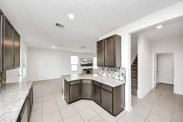 a kitchen with granite countertop a sink and cabinets