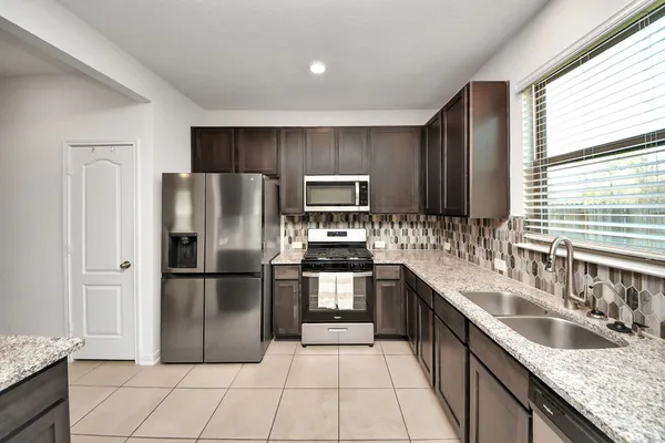 a bathroom with a sink a mirror and a window