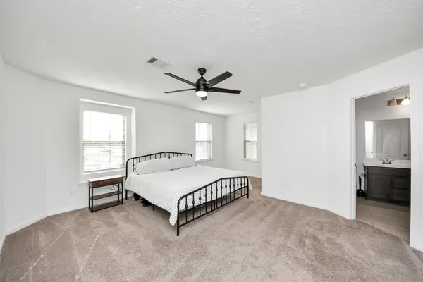 a bathroom with a double vanity sink a toilet and a bathtub