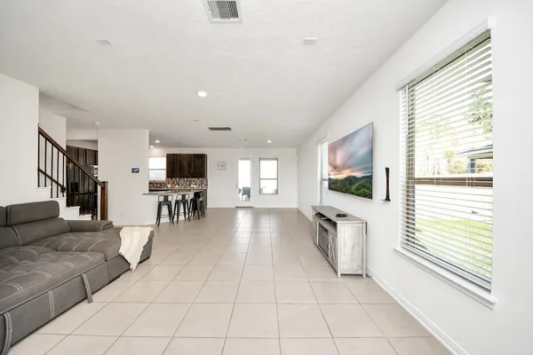 a lobby with furniture and flat screen tv