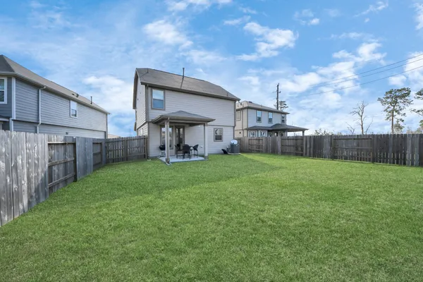 a view of a lake in front of residential houses with outdoor space