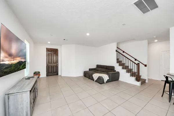 a living room with furniture and a flat screen tv