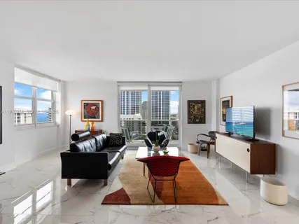 a living room with furniture chess board and a window