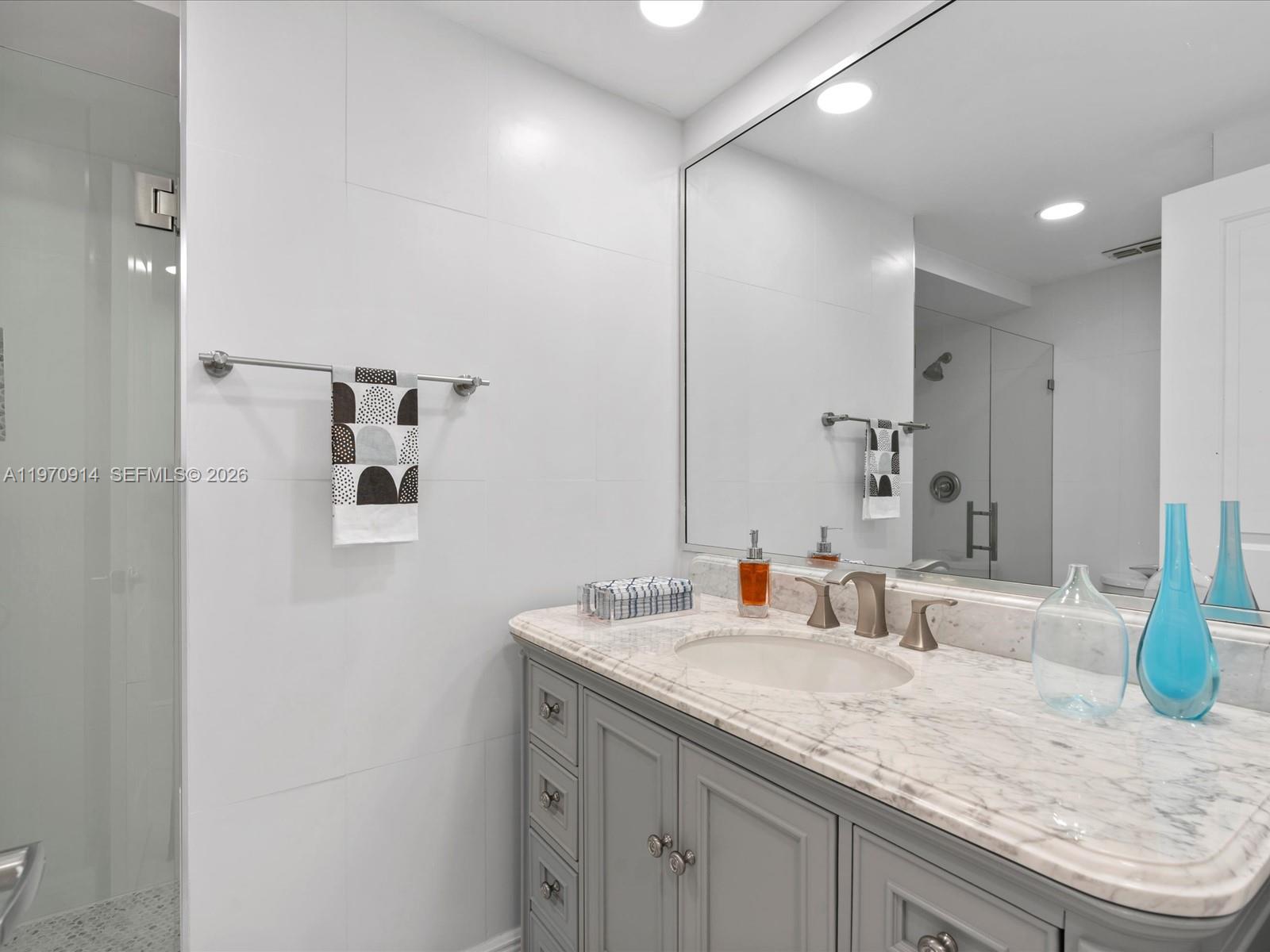 336 North Birch Road, Unit PH Fort Lauderdale, FL 33304 - Photo 20 of 68 a bathroom with a granite countertop sink and a mirror