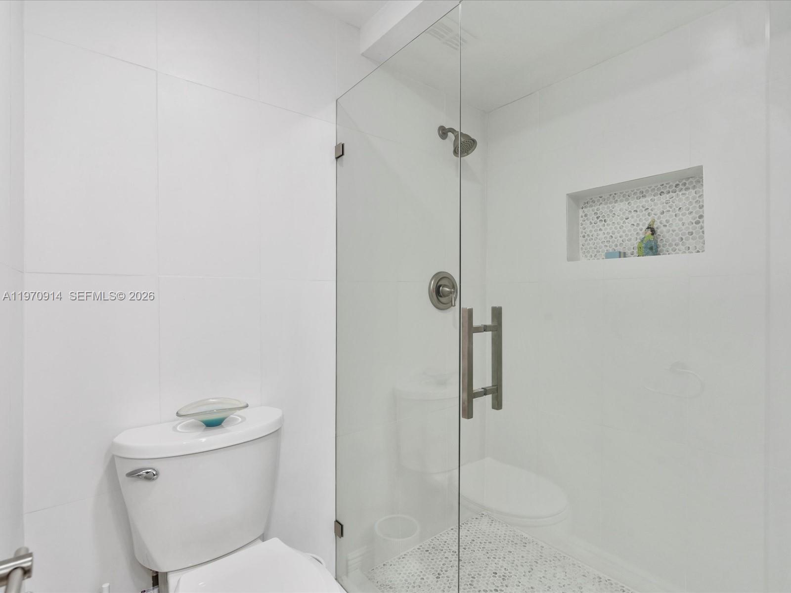 336 North Birch Road, Unit PH Fort Lauderdale, FL 33304 - Photo 21 of 68 a white toilet sitting next to a shower