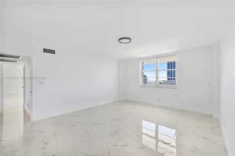 a view of a hallway with wooden floor and closet area