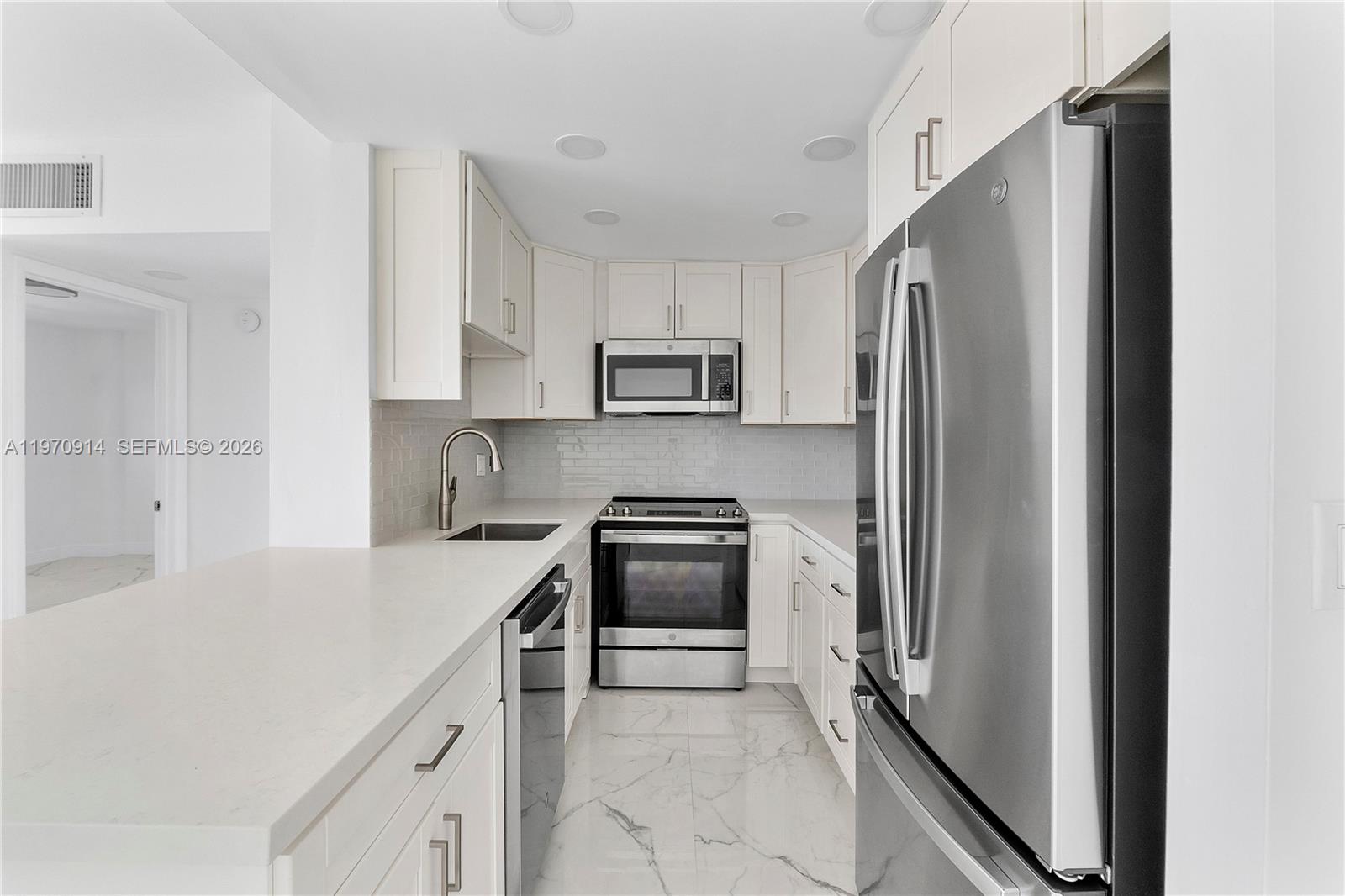 336 North Birch Road, Unit PH Fort Lauderdale, FL 33304 - Photo 7 of 68 a kitchen with a refrigerator sink and stove top oven