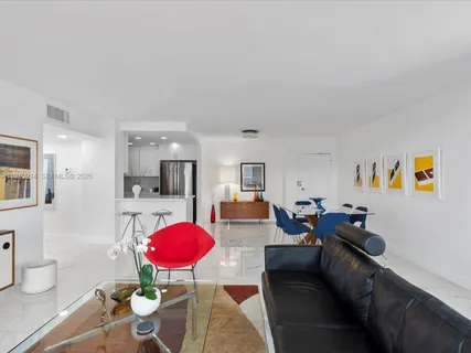 a living room with furniture a rug and a large window