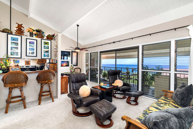 79-7199 Kona Coffee Villas, Unit 315 Holualoa, HI 96725 - Photo 3 of 28 a living room filled with furniture and floor to ceiling windows