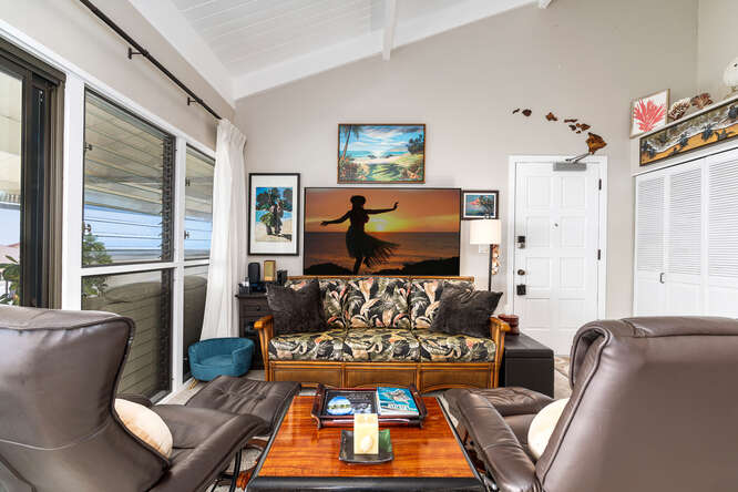 79-7199 Kona Coffee Villas, Unit 315 Holualoa, HI 96725 - Photo 4 of 28 a living room with furniture and a flat screen tv