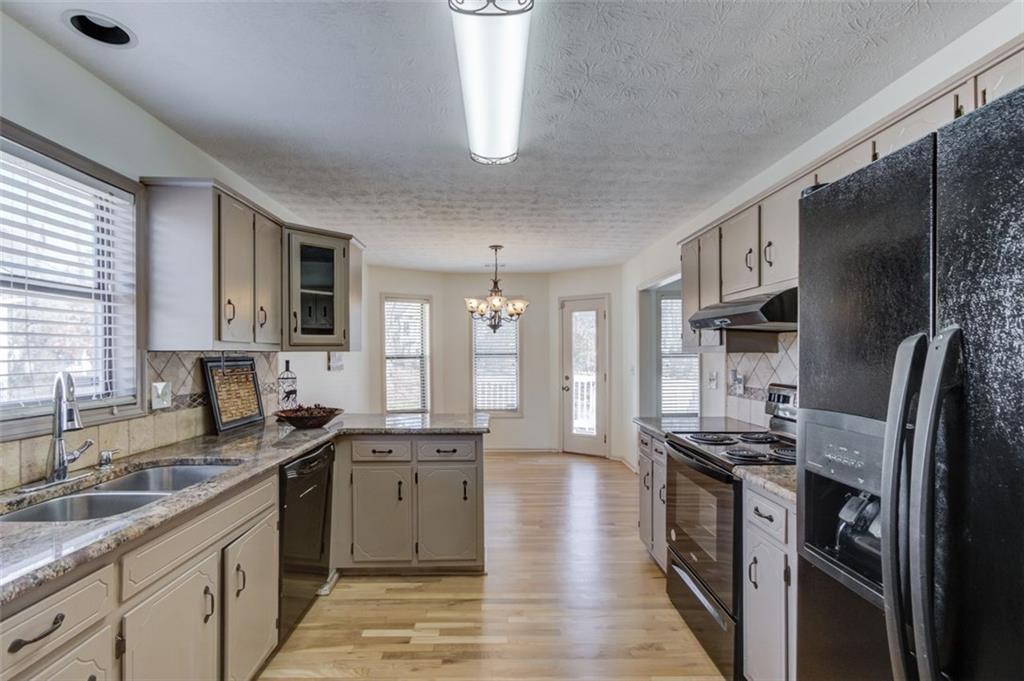 2965 Cordite Loop Snellville, GA 30039 - Photo 18 of 45 a kitchen with stainless steel appliances granite countertop a sink stove and refrigerator