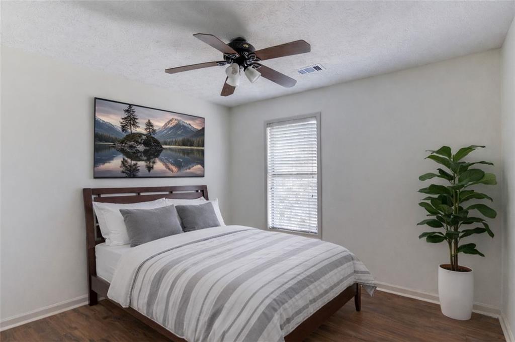2965 Cordite Loop Snellville, GA 30039 - Photo 29 of 45 a bedroom with a large bed and a potted plant