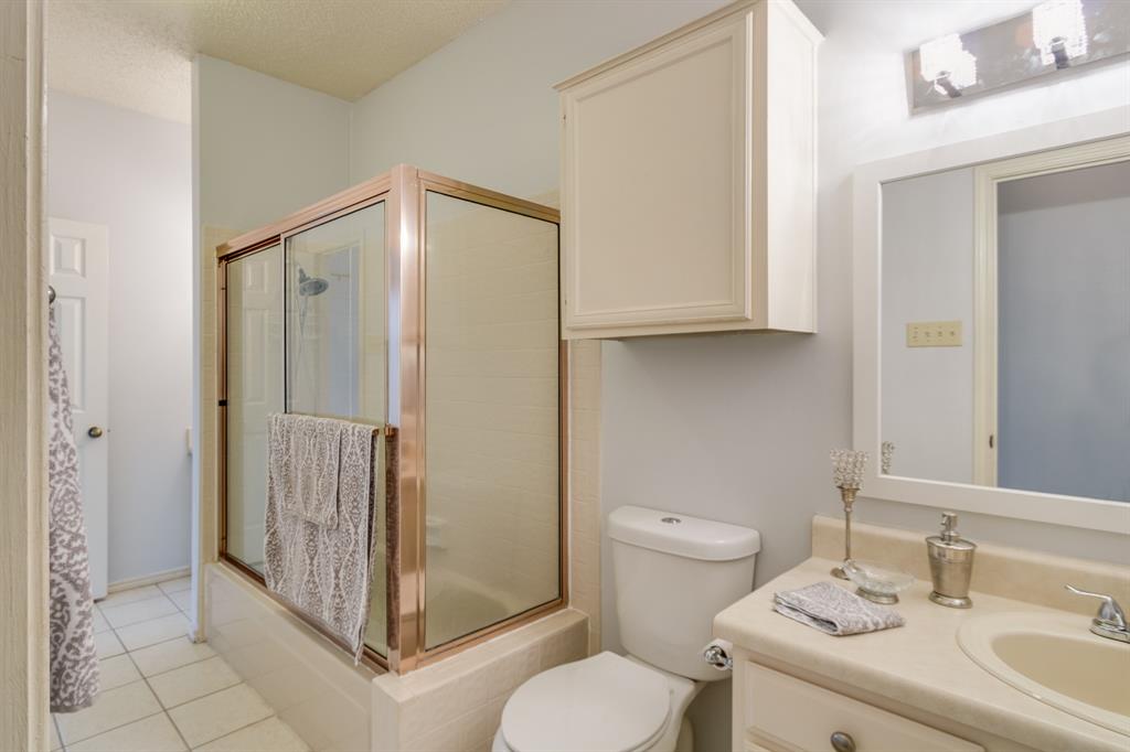 2100 Randy Snow Road, Unit 412 Arlington, TX 76011 - Photo 16 of 32 a bathroom with a granite countertop sink mirror vanity and toilet