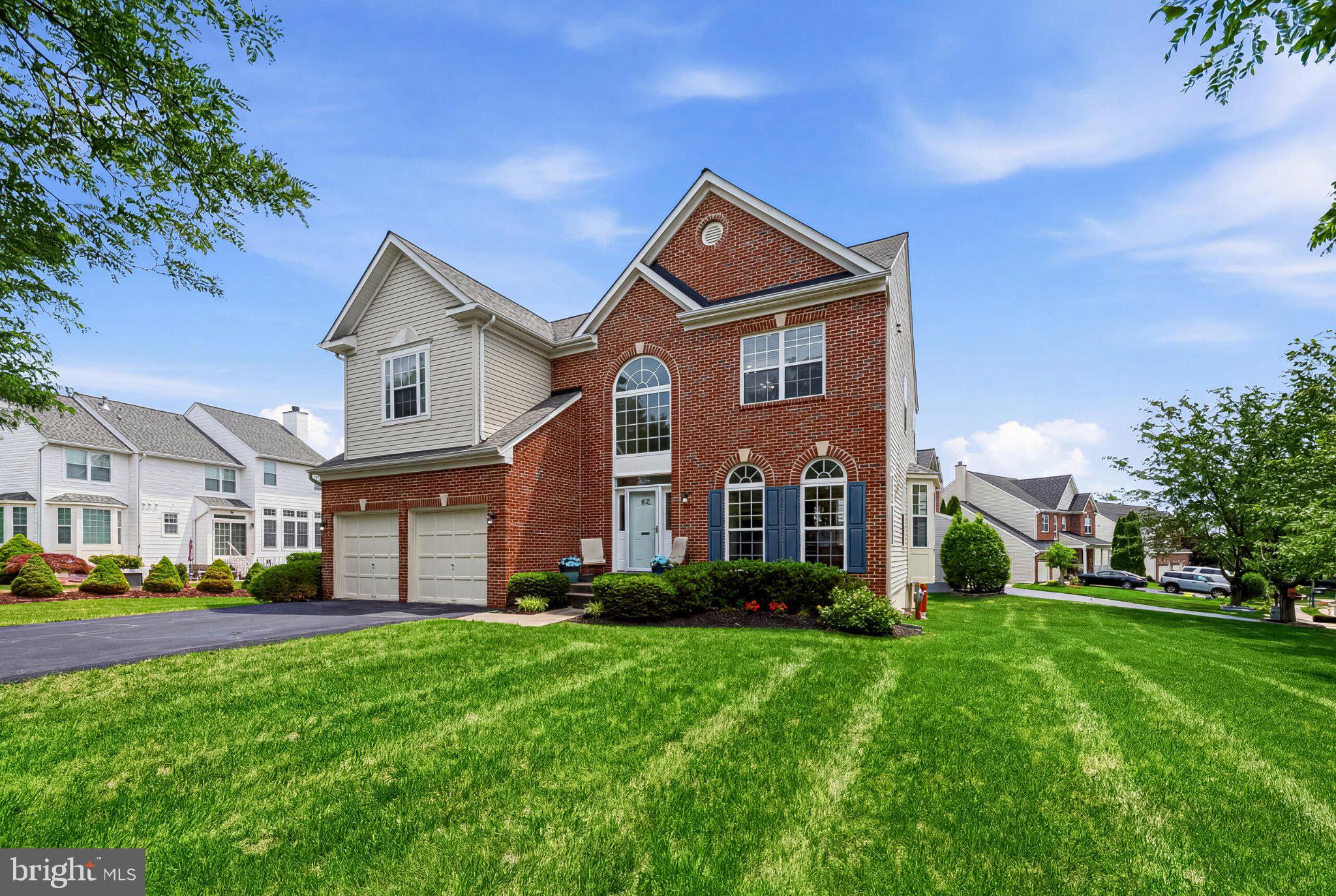 Charming brick home with lush lawn.
