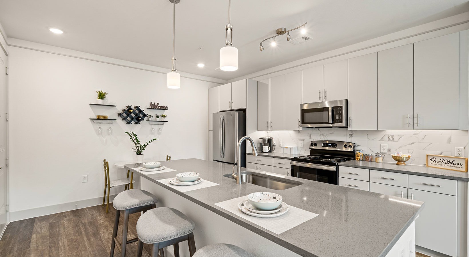 1700 Katy Fort Bend Road, Unit 111304 Katy, TX 77493 - Photo 7 of 30 a kitchen with stainless steel appliances kitchen island granite countertop a stove a sink a dining table and chairs